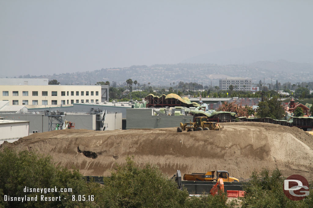 The mound of dirt is slowly disappearing.  As dirt is used they continue to level/sculpt it.