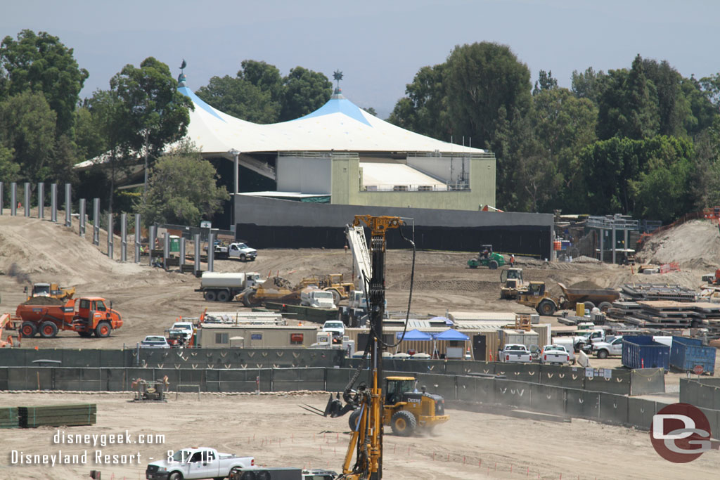 Dirt is being moved and filling in behind the retaining wall.