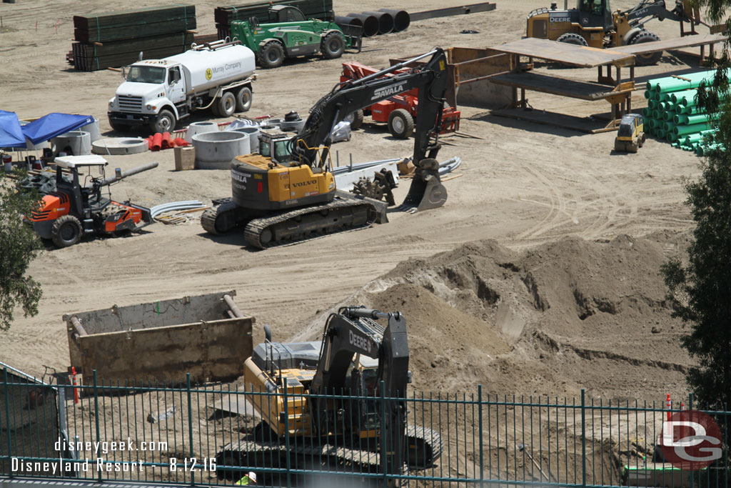 Utility work progresses nearest the fence line.