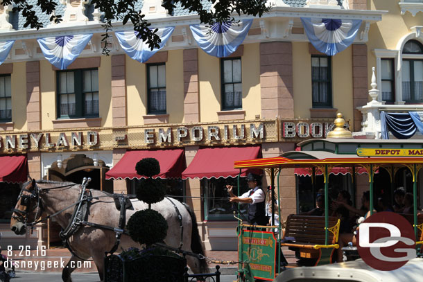 A horse drawn street car passing by.