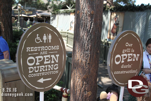 Signs by the entrance to the Hungry Bear indicating they are open as well as the restrooms.