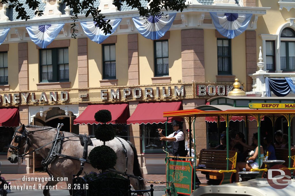 A horse drawn street car passing by.