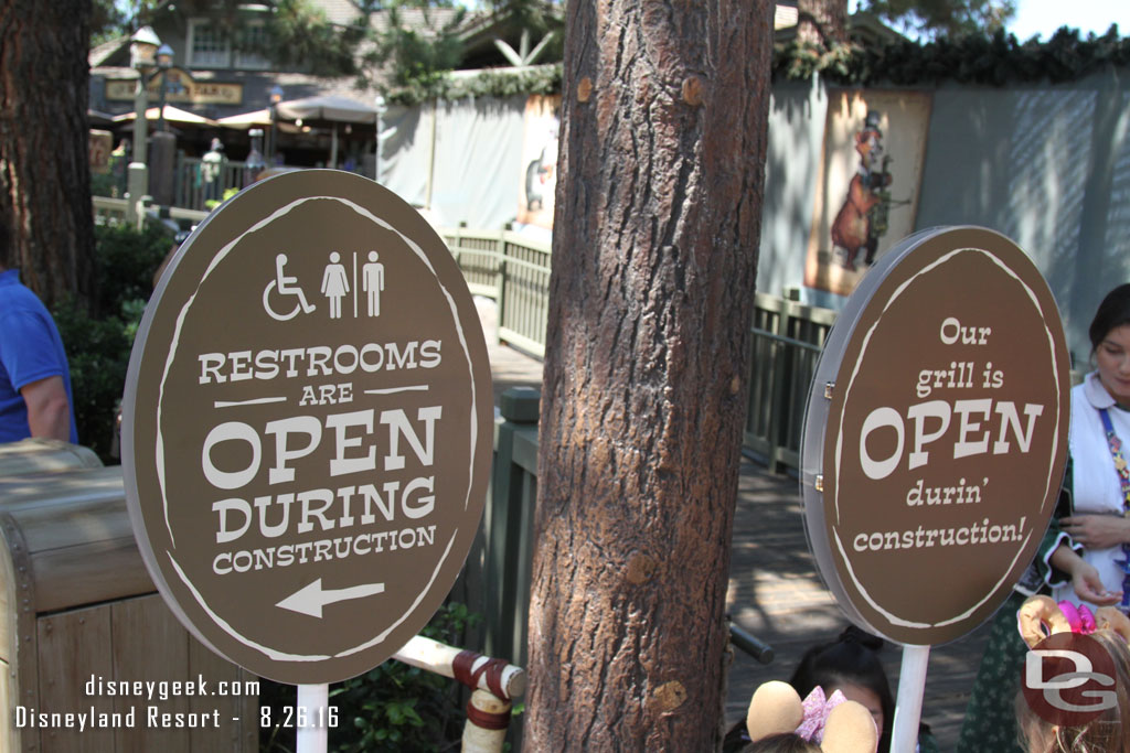 Signs by the entrance to the Hungry Bear indicating they are open as well as the restrooms.