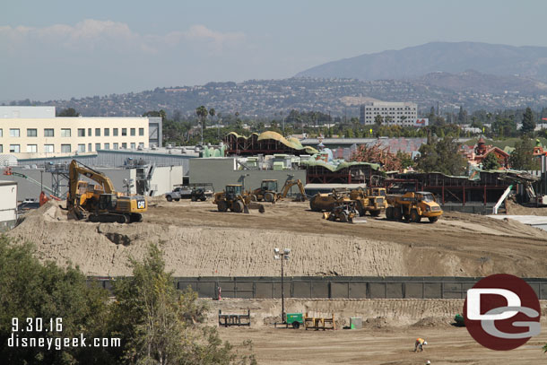 A pan across the site starting on the left/north side.  The mound of dirt continues to evolve.