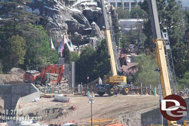 You can see the top of the steel support structures just topping the dirt the crane is on.  That will be for the rock work along the Big Thunder Trail.  