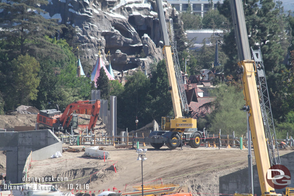 You can see the top of the steel support structures just topping the dirt the crane is on.  That will be for the rock work along the Big Thunder Trail.  