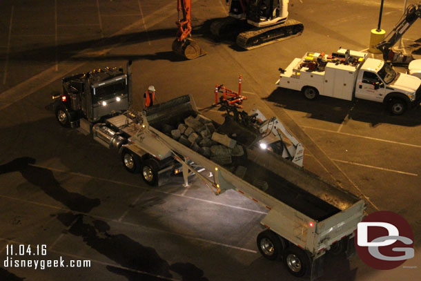 A small bobcat loading concrete pieces from the parking structure.