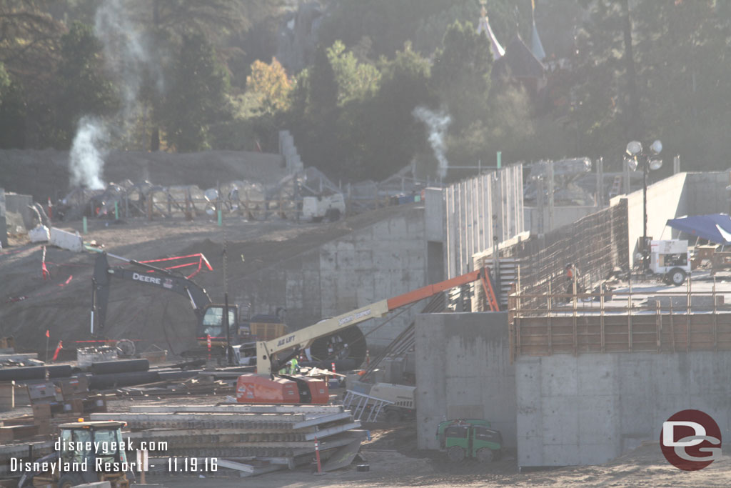 You can see the rock work wire mesh now sticking up above the dirt.  Assuming the smoke is from welders working on it this morning.