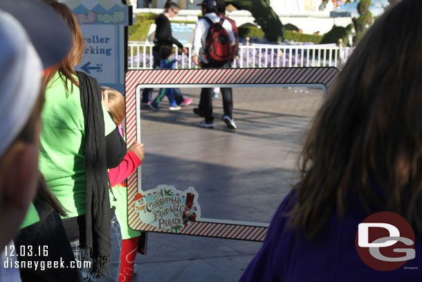 In front of Small World a couple photopass photographers with frames.