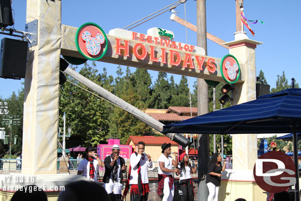 RAISE performing at the Pacific Wharf Stage as part of Disney Festival of Holidays