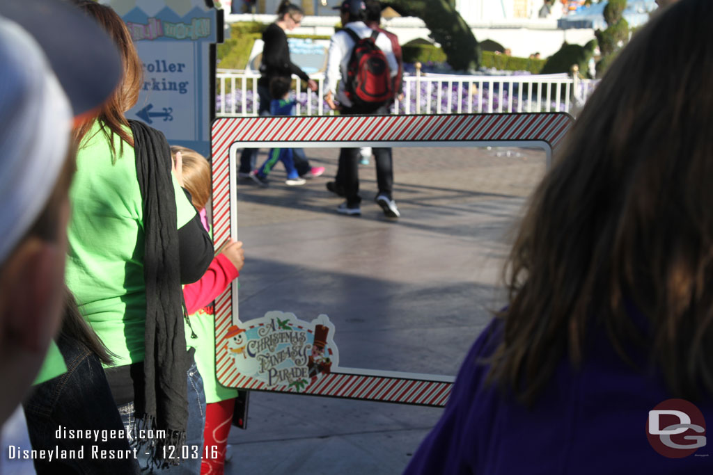 In front of Small World a couple photopass photographers with frames.