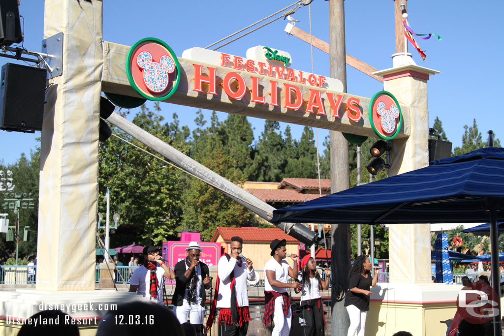 RAISE performing at the Pacific Wharf Stage as part of Disney Festival of Holidays