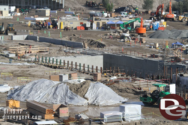 In the near lot work continues on the basement and foundation for a show building.