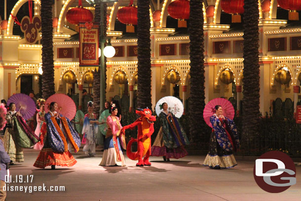 Mulan and Mushu leading the procession.