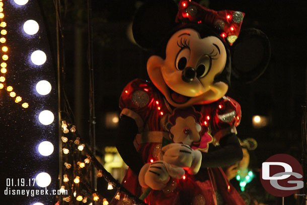 Minnie holding a flower.