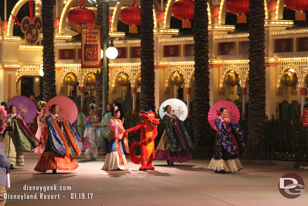 Mulan and Mushu leading the procession.