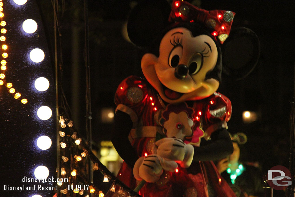 Minnie holding a flower.