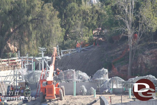 On the far hill where the worker is standing there is some steel.  Could not tell if that is just placed there as a staging location or for a rock structure on the island.