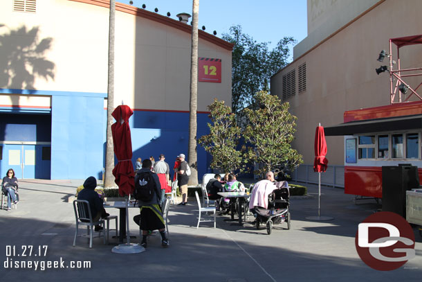 Guests hanging out at the tables near stage 12.