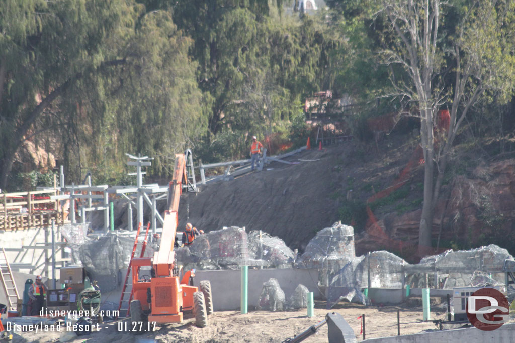 On the far hill where the worker is standing there is some steel.  Could not tell if that is just placed there as a staging location or for a rock structure on the island.