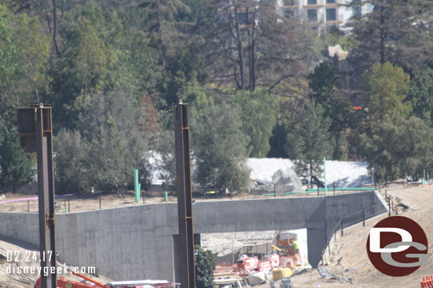 Trees atop the tunnel along berm.