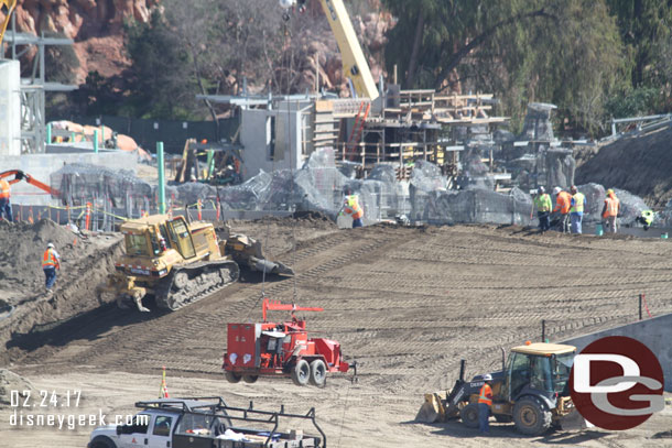 Work on the berm as they bring in and compact more dirt.