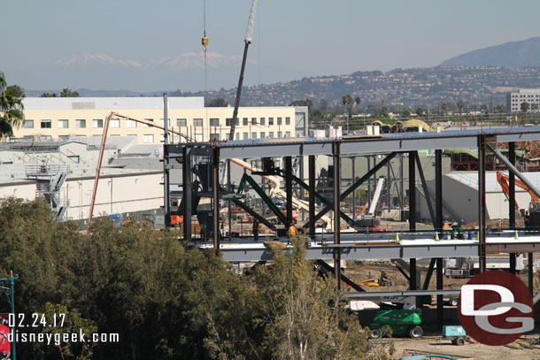 Concrete was being poured for the foundation of another building just beyond the large one.