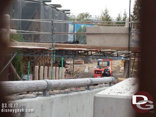 Looking through the fence at the walkway.  Scaffolding up as they work on something that will go over part of it.