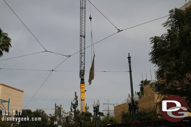 A large crane is onside and parked behind walls onstage.  It is holding a banner.  Guess an attempt to give it some purpose while not in use.