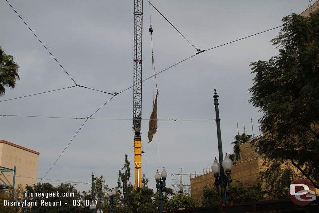 A large crane is onside and parked behind walls onstage.  It is holding a banner.  Guess an attempt to give it some purpose while not in use.