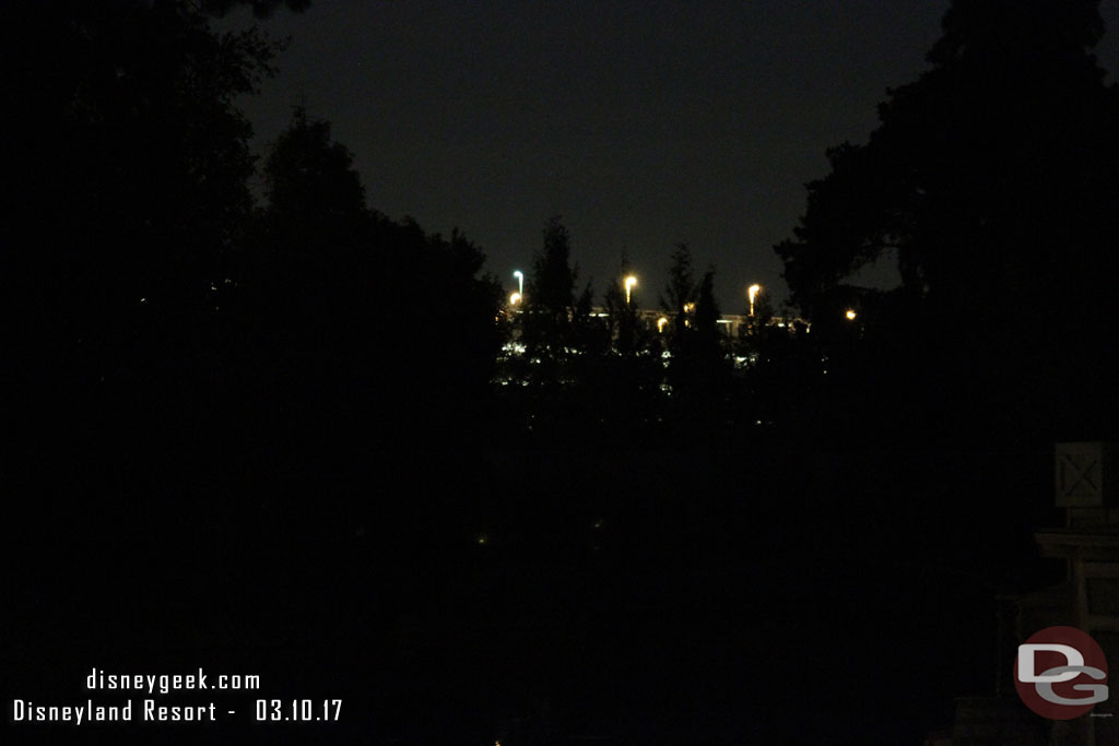 Hard to see.. but this is the view from the Rivers of America.  the new trees currently block a good portion of the parking structure lights.  Once they grow in it will be better (also not sure if all are in place and if any buildings will help too.