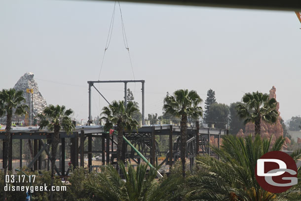 Through the trees you can see the AT-ATs in the new show building.  Today they were adding more steel to the roof.