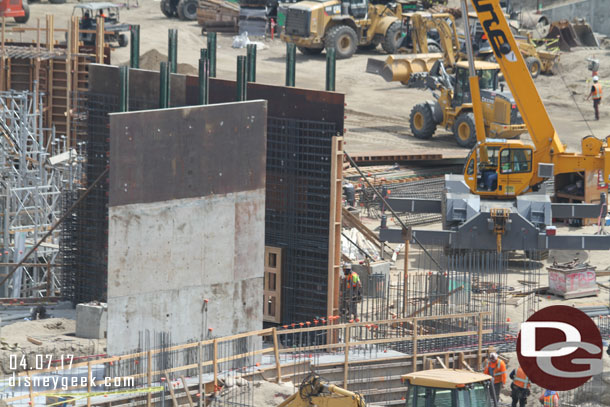 To get a sense of scale notice the worker.  The walls are well over 20ft assuming he is an average 6ft tall person.