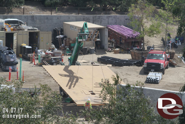 A team moving a large wall form around.