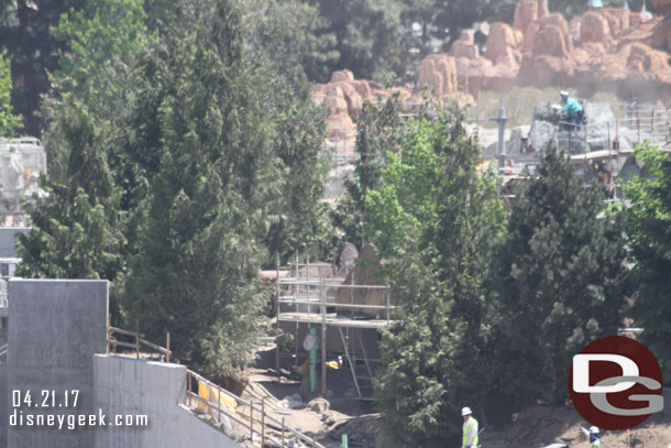 The rock work blocking the pipe in the foreground.  In the background more rock formations over the trees.