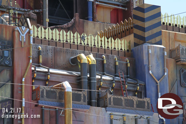 Some ladders and workers seen around the building.