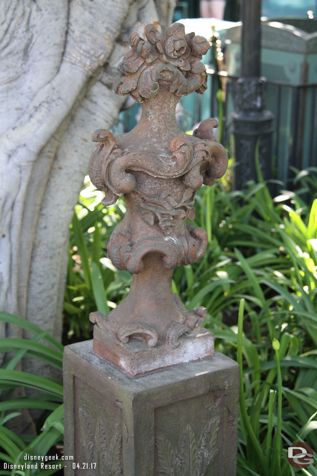 In some of the planters of New Orleans Square some new statues have appeared over top of utility plates.