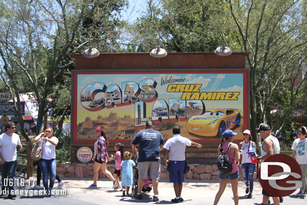 The Cars Land Entrance is out from behind walls. In addition to including Cruz Ramirez the planter has been removed so you can go right up to the sign.  