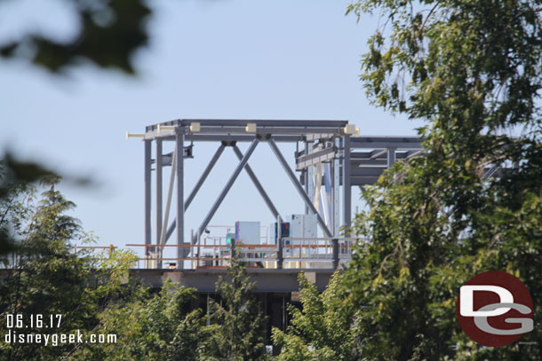 The top of the Star Wars buildings is visible over the tree line.