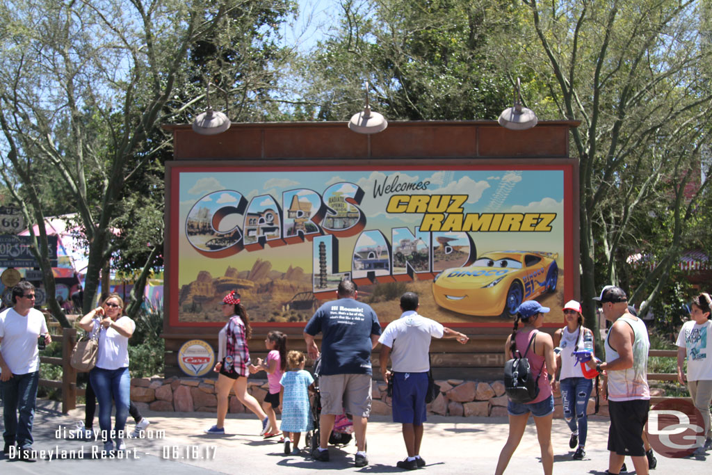 The Cars Land Entrance is out from behind walls. In addition to including Cruz Ramirez the planter has been removed so you can go right up to the sign.  