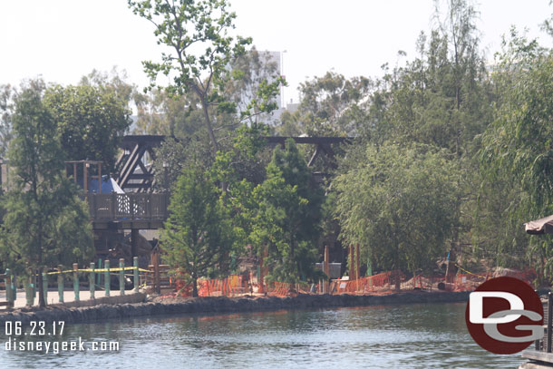 The view of the trestle is obstructed with quite a few trees.