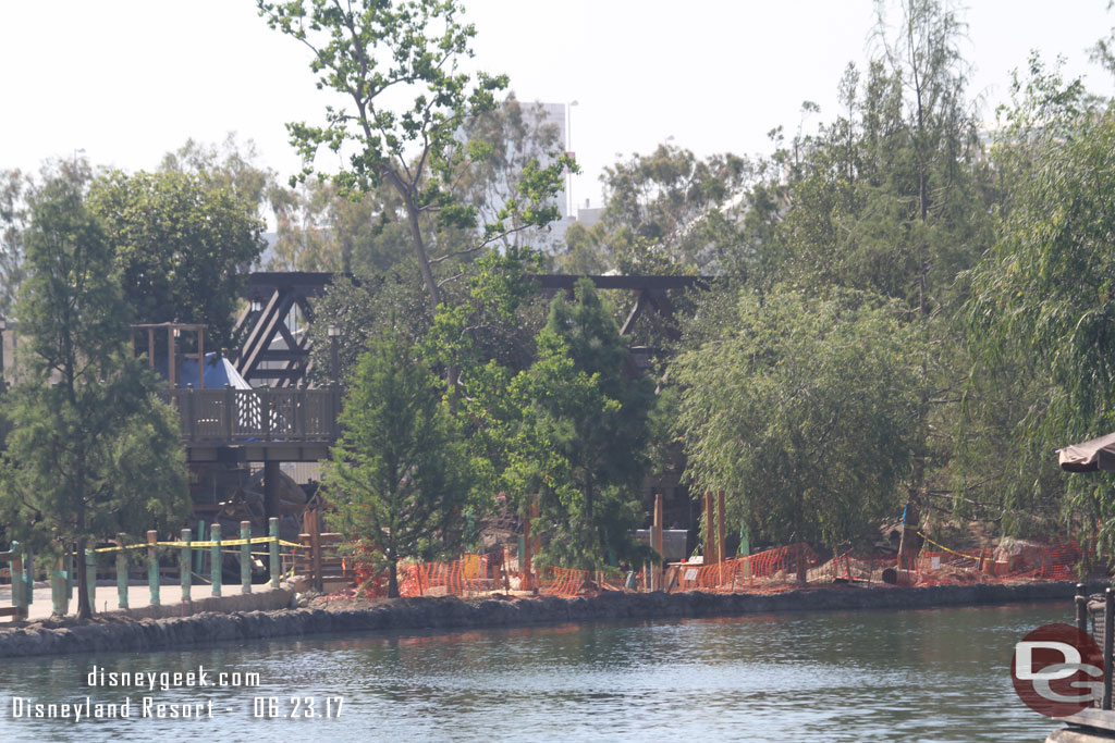 The view of the trestle is obstructed with quite a few trees.