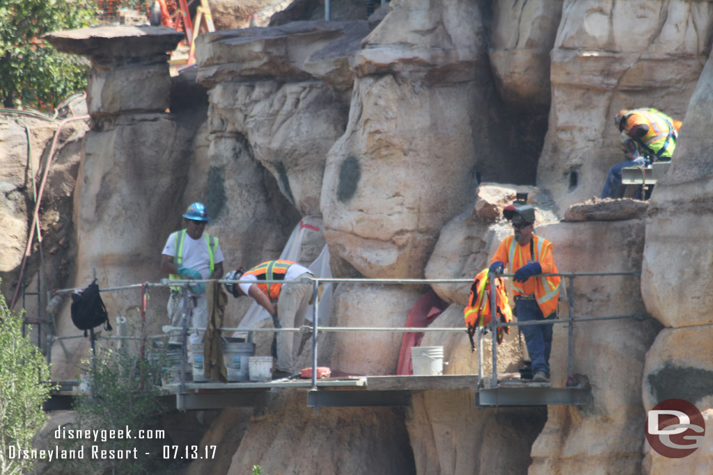 Crews removing the scaffolding and patching the holes with concrete.