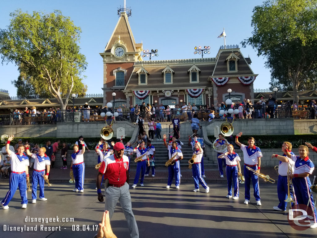 The Disneyland 2017 All-American College Band performing in Town Square.   Notice the train line behind them filling the platform level and coming down the steps.