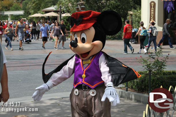 Mickey Mouse showing off his cape.