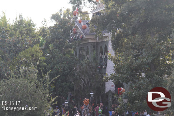 Haunted Mansion Holiday through the trees