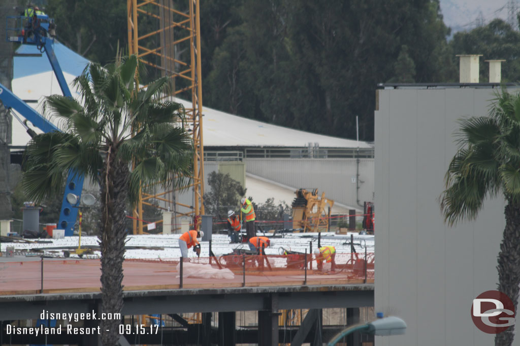 Crews working on  the roof of the Millennium Falcon building.