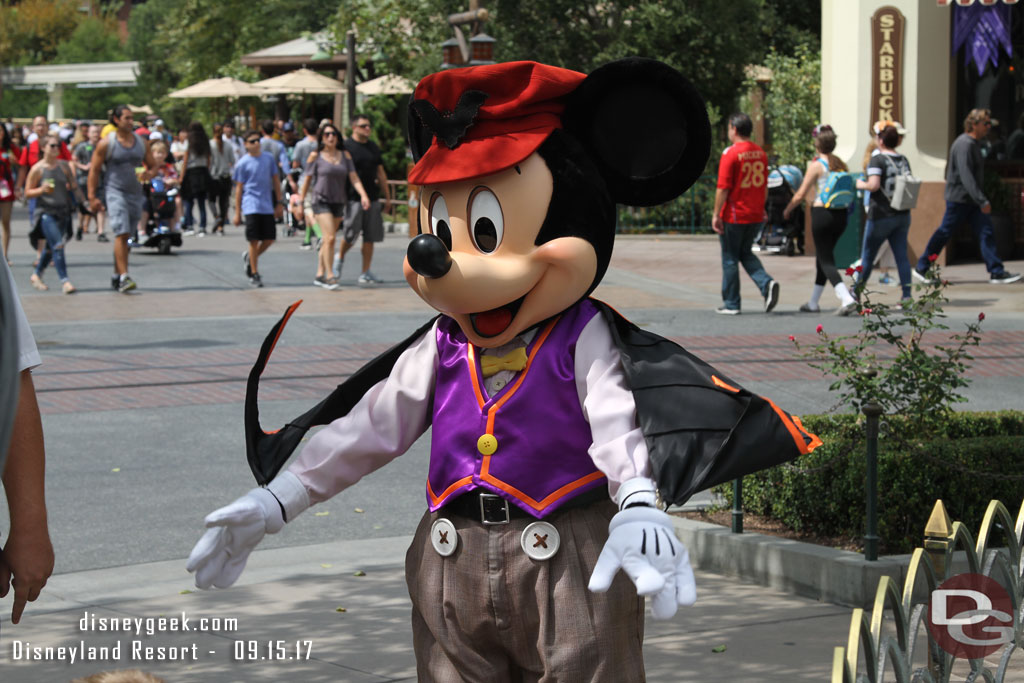 Mickey Mouse showing off his cape.