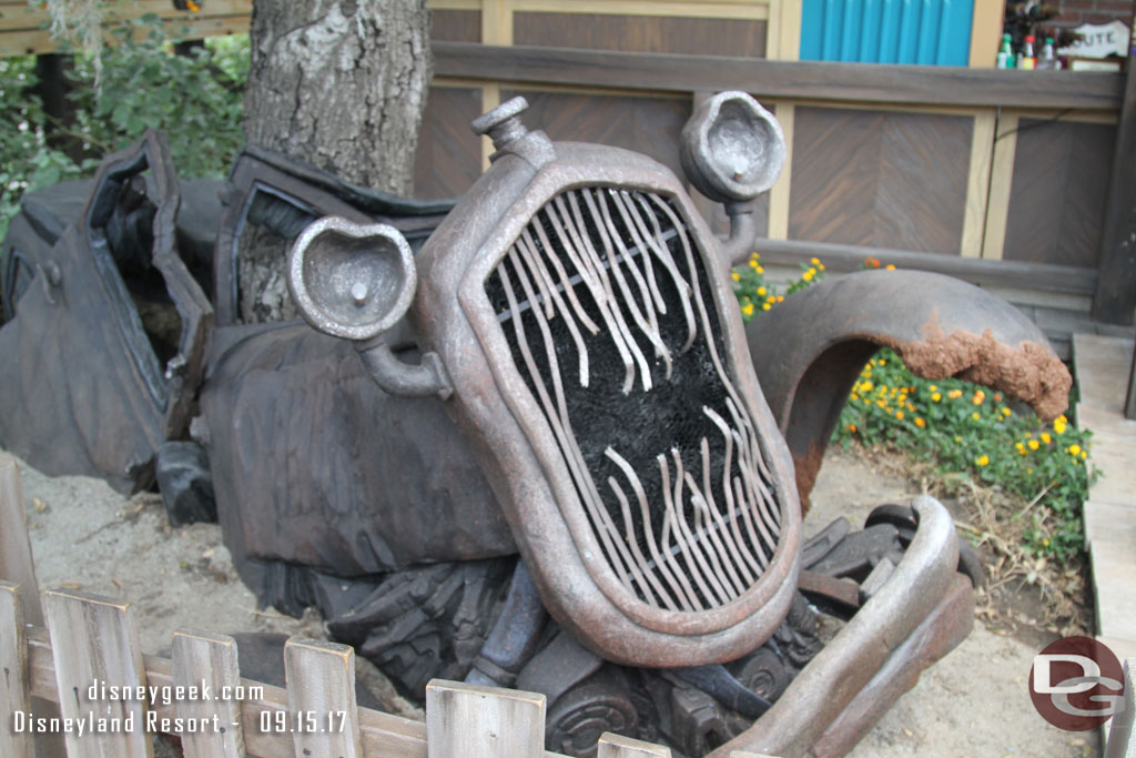 In front of Radiator Springs Curios is this old/ghost car wreck.