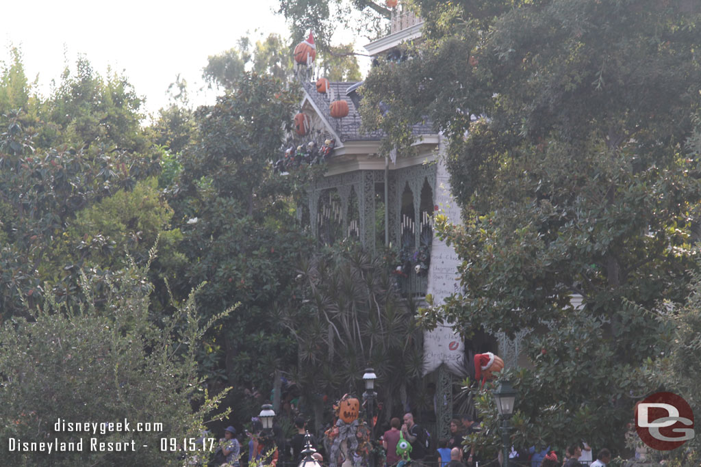 Haunted Mansion Holiday through the trees